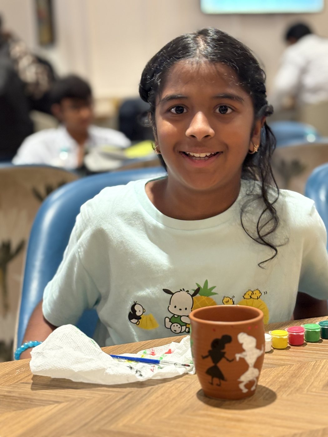 Anshika painting a pot